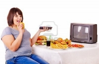 14092469-overweight-woman-eating-fast-food-and-watching-tv-isolated